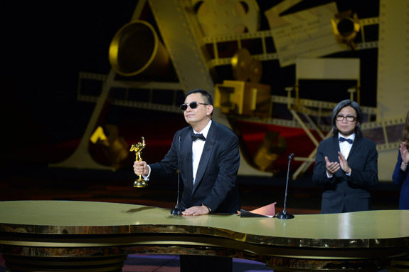 Wong Kar Wai, director of The Grandmaster, receives the award for Best Film from Peter Chan and Isabelle Huppert